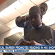 Royal Touch Barbershop owner Reggie Ross gives a touch-up to a young customer while he reads in Palm Beach County, Fla.
WPTV screenshot